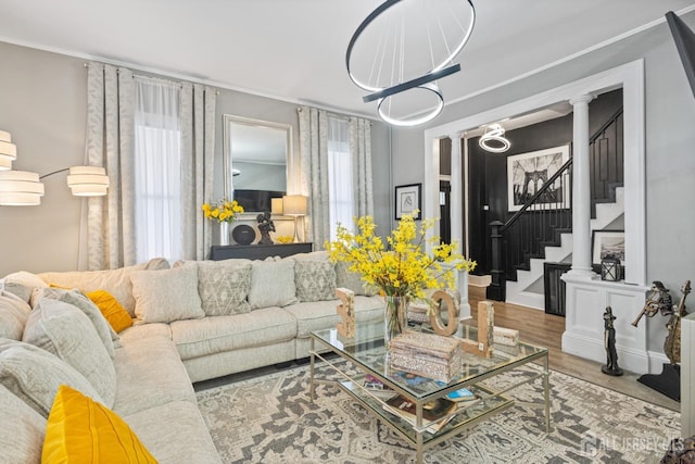 207 S Broadway, South Amboy, NJ 08879 - living area featuring stairway, wood finished floors, ornate columns, and crown molding