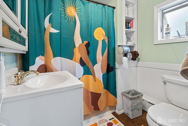 207 S Broadway, South Amboy, NJ 08879 - bathroom with toilet, vanity, wood finished floors, a shower with curtain, and a baseboard heating unit