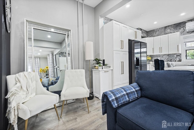 207 S Broadway, South Amboy, NJ 08879 - living area featuring light wood-type flooring, a wall mounted air conditioner, and recessed lighting