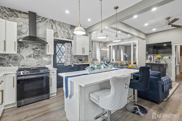 207 S Broadway, South Amboy, NJ 08879 - kitchen featuring gas range, extractor fan, open floor plan, a kitchen island, and white cabinetry