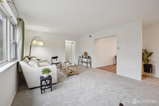 carpeted living area featuring visible vents