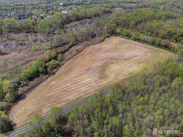 aerial view of property's location featuring a forest