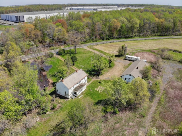 aerial view of sparsely populated area with a heavily wooded area