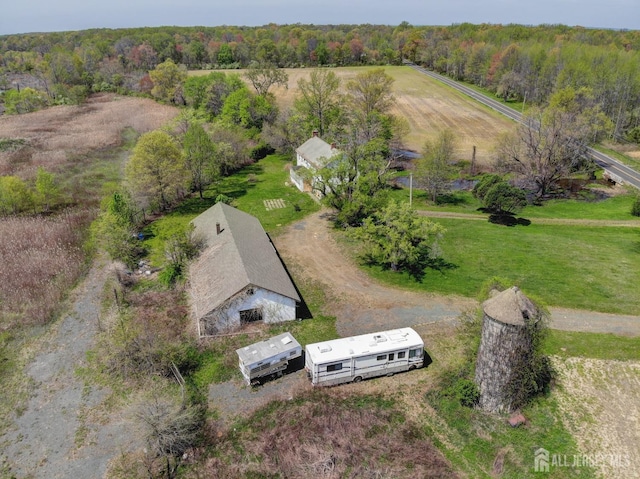 aerial view of property and surrounding area featuring a forest