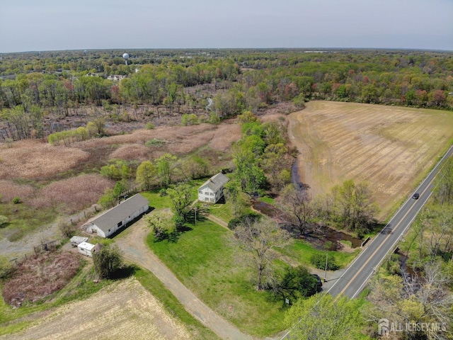 view of property location featuring a forest
