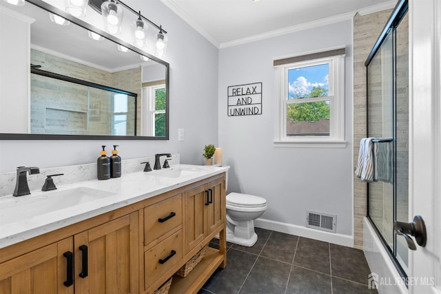 bathroom featuring toilet, tile patterned flooring, double vanity, ornamental molding, and baseboards