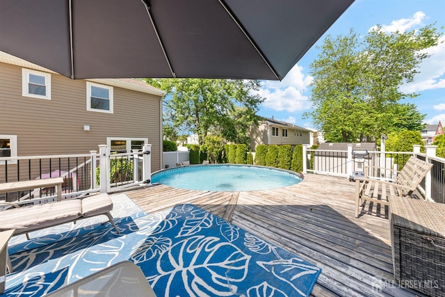 outdoor pool featuring a wooden deck
