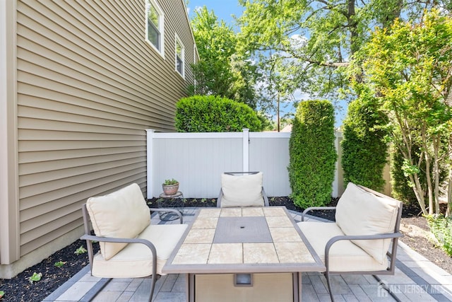 view of patio with fence and outdoor dining area