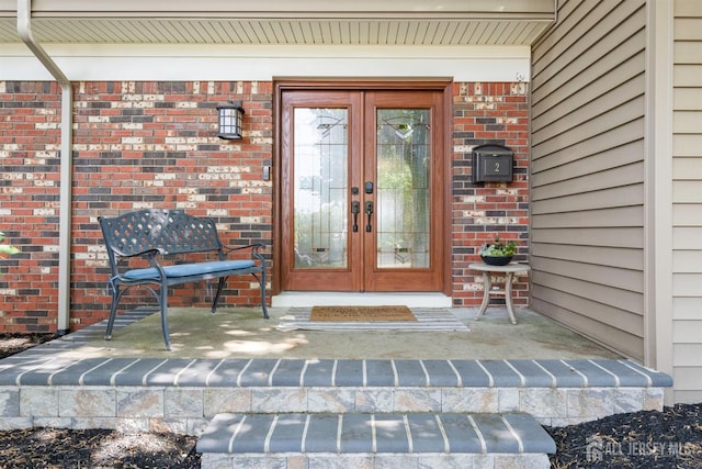 entrance to property with french doors and brick siding
