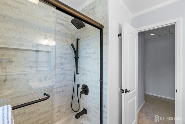 bathroom featuring a shower stall, crown molding, and baseboards