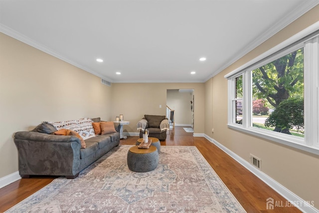 living room with ornamental molding, baseboards, recessed lighting, and wood finished floors