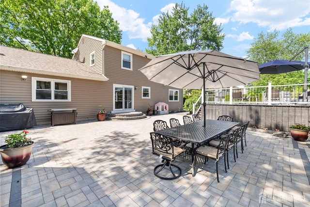 view of patio with fence and outdoor dining area
