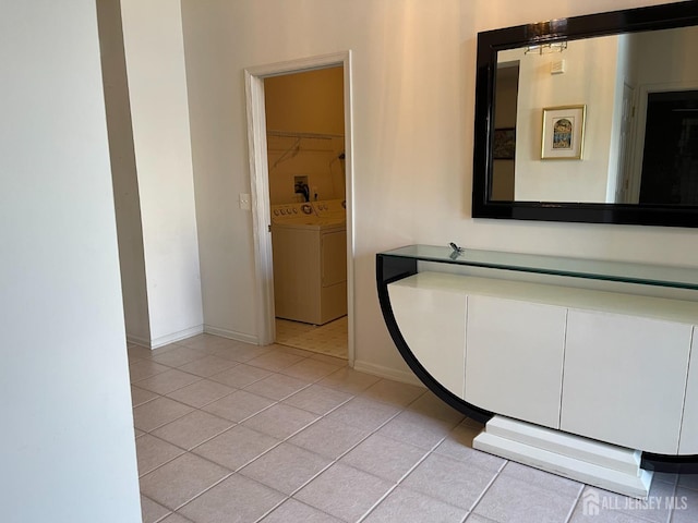 bathroom with independent washer and dryer and tile patterned flooring