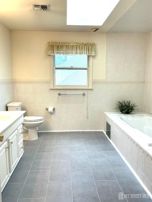 20 Ballo Pl, Edison, NJ 08820 - full bathroom with tile walls, tile patterned floors, tiled tub, vanity, and a wainscoted wall