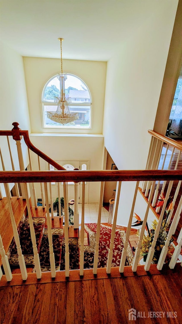20 Ballo Pl, Edison, NJ 08820 - stairway featuring plenty of natural light, a chandelier, and wood finished floors