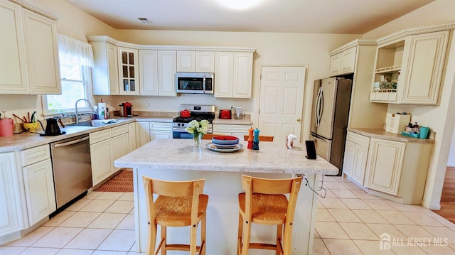 20 Ballo Pl, Edison, NJ 08820 - kitchen with appliances with stainless steel finishes, a center island, a kitchen breakfast bar, and light tile patterned floors