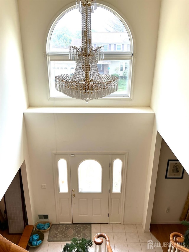 20 Ballo Pl, Edison, NJ 08820 - entrance foyer with a chandelier, light tile patterned floors, and a towering ceiling