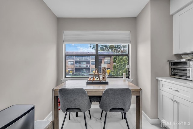 dining area with a desk and baseboards