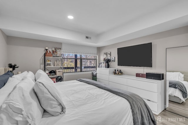 bedroom with light wood-style floors and recessed lighting