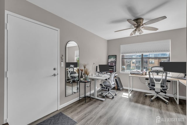 office with wood finished floors, a ceiling fan, and baseboards