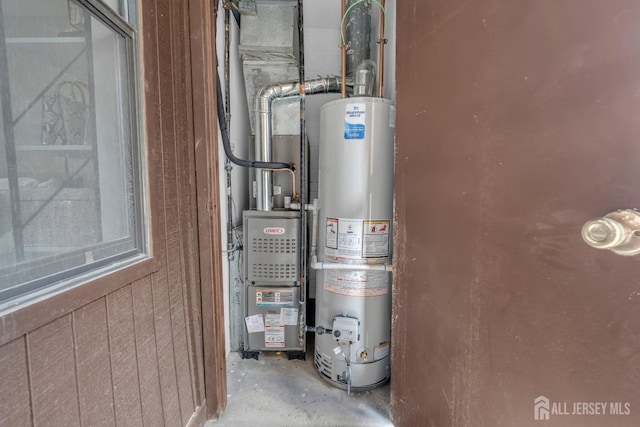 utility room featuring water heater
