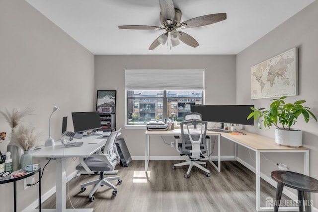 office space featuring wood finished floors, ceiling fan, and baseboards