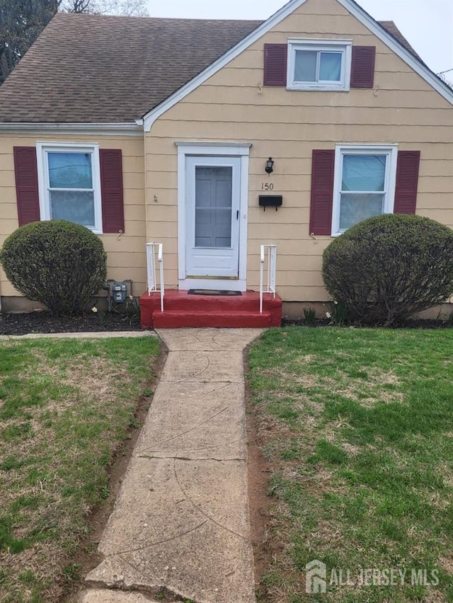 150 Morton Ave, South Plainfield, NJ 07080 - bungalow featuring a shingled roof and a front lawn