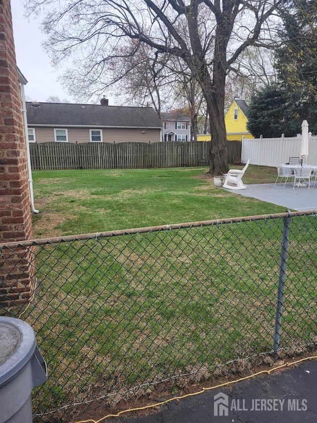 view of yard with a patio and fence