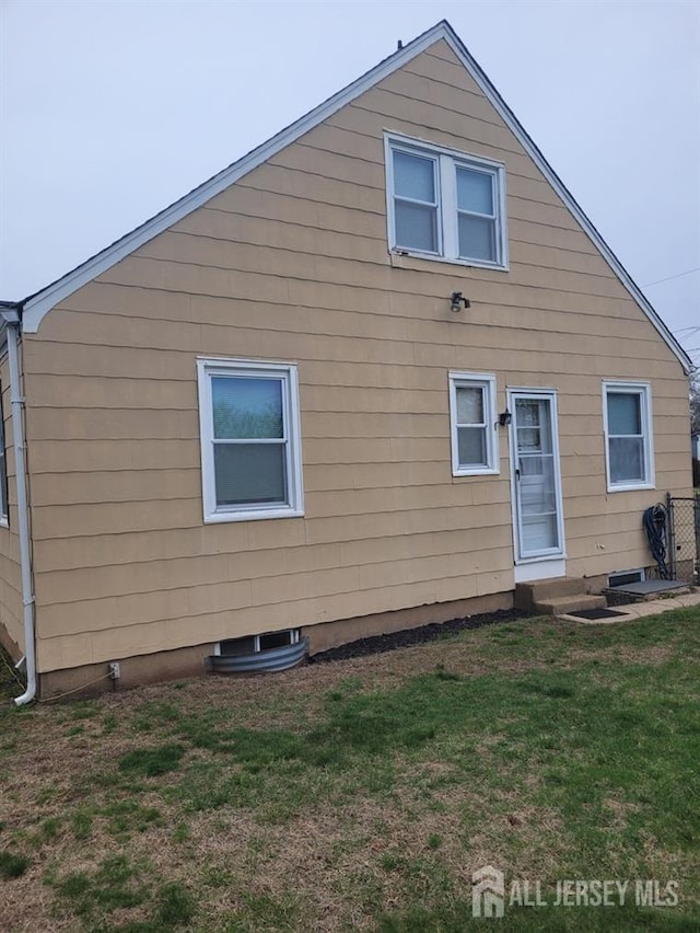 rear view of property with a yard