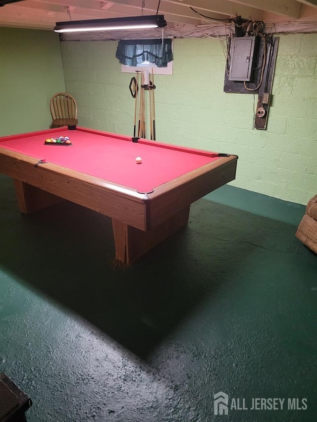 rec room with concrete block wall, electric panel, and pool table