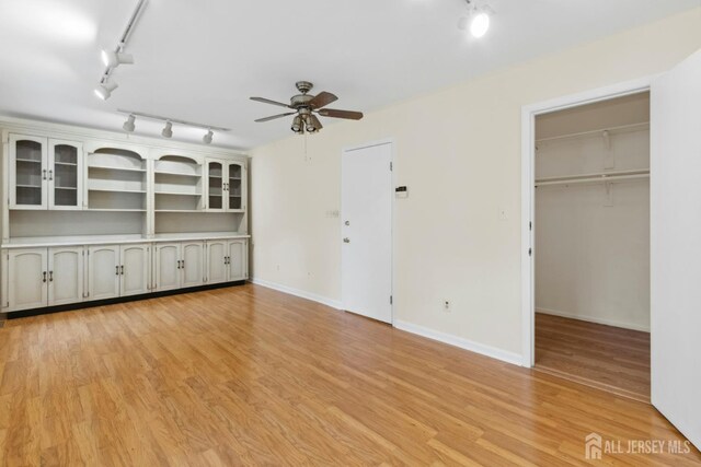 7 Tisbury Ct, Scotch Plains, NJ 07076 - unfurnished living room featuring track lighting, ceiling fan, and light wood-style floors