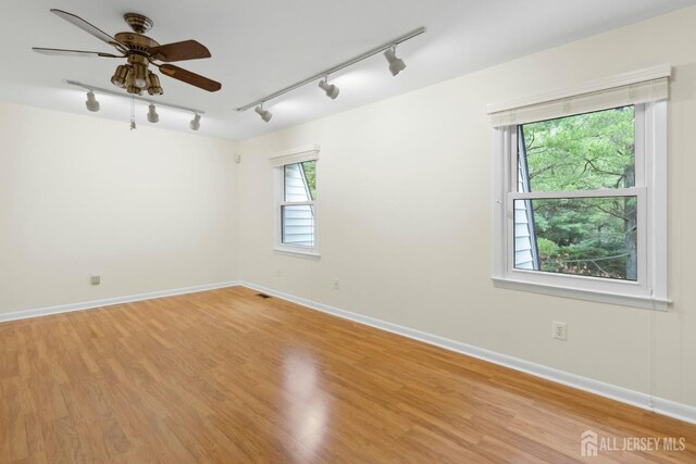 7 Tisbury Ct, Scotch Plains, NJ 07076 - spare room with rail lighting, light wood finished floors, and ceiling fan
