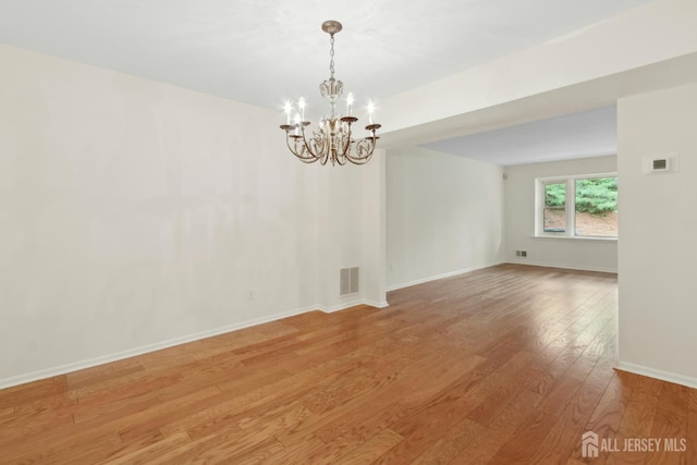 7 Tisbury Ct, Scotch Plains, NJ 07076 - empty room featuring a chandelier and light wood finished floors