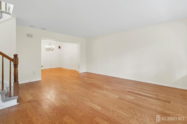 7 Tisbury Ct, Scotch Plains, NJ 07076 - unfurnished room with a chandelier, light wood finished floors, and stairs