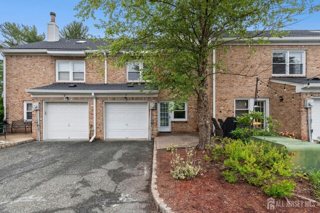 7 Tisbury Ct, Scotch Plains, NJ 07076 - traditional home featuring asphalt driveway, an attached garage, a chimney, and brick siding
