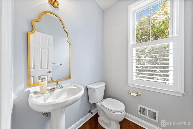 19 S Shore Dr, South Amboy, NJ 08879 - half bath with baseboards, toilet, and wood finished floors