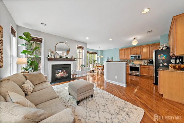 19 S Shore Dr, South Amboy, NJ 08879 - living room featuring light wood-style flooring, recessed lighting, a fireplace with flush hearth, and baseboards