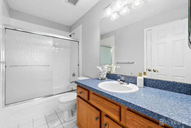 19 S Shore Dr, South Amboy, NJ 08879 - bathroom featuring tile patterned floors, toilet, vanity, and bath / shower combo with glass door