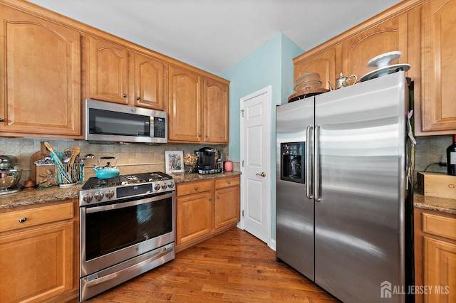 19 S Shore Dr, South Amboy, NJ 08879 - kitchen with stainless steel appliances, dark wood finished floors, stone countertops, tasteful backsplash, and brown cabinetry