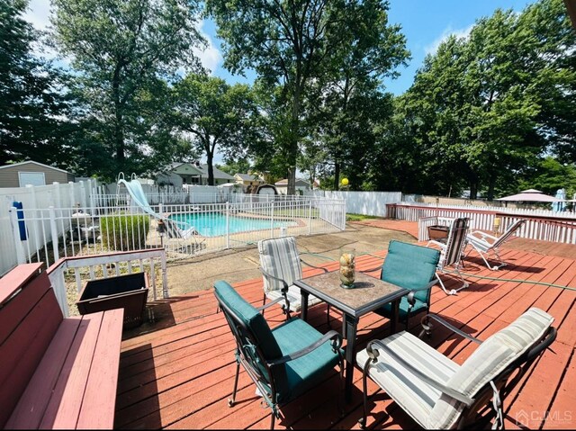 wooden deck featuring a fenced in pool