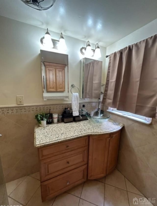 bathroom with wainscoting, tile walls, and tile patterned floors