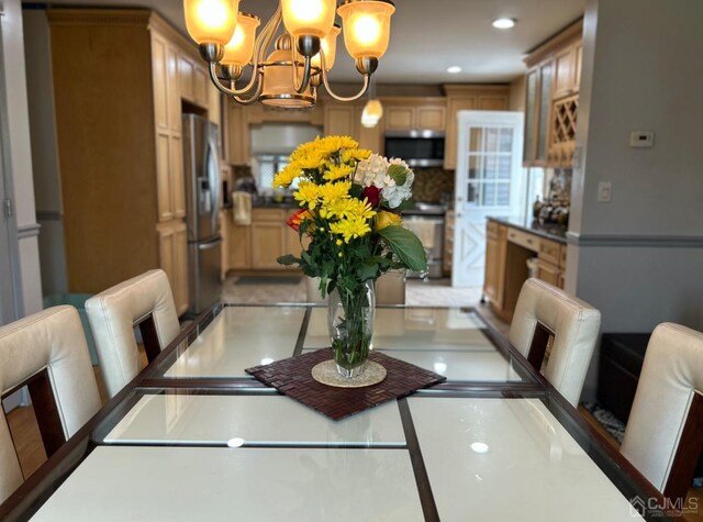 dining area with an inviting chandelier