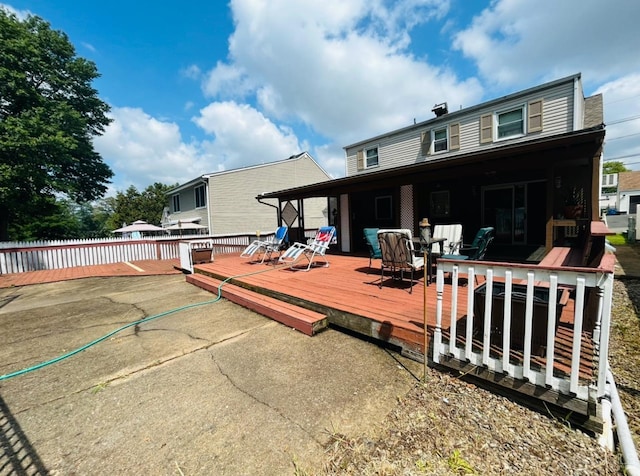 rear view of house with a wooden deck