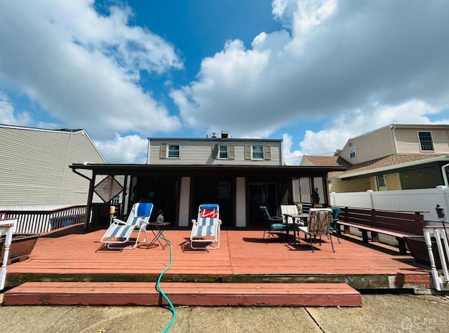 rear view of property featuring a deck