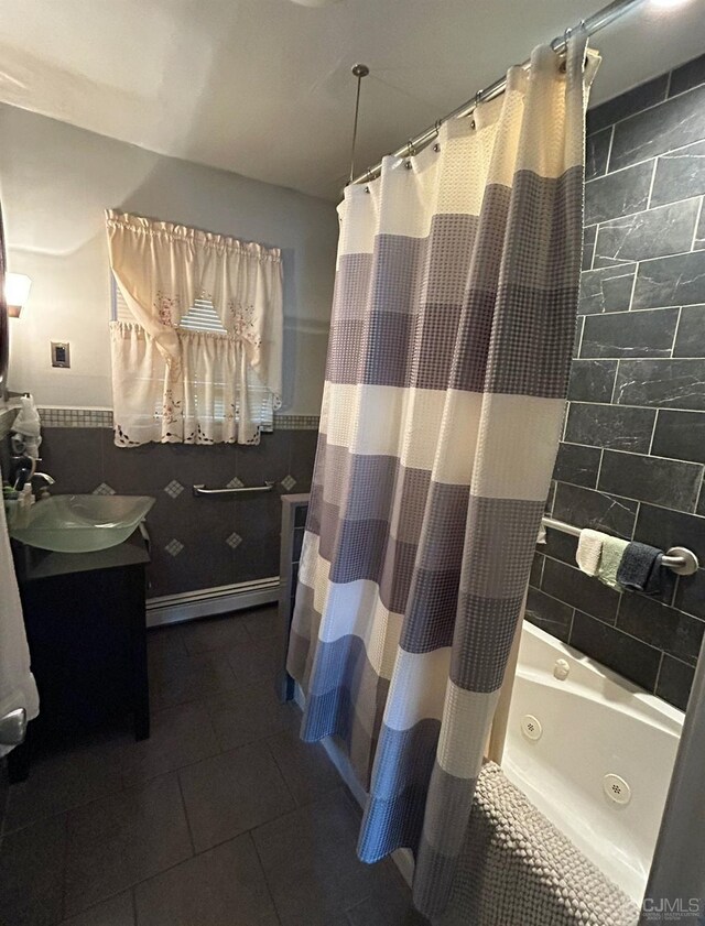 bathroom featuring shower / tub combo with curtain, vanity, a baseboard radiator, and tile walls