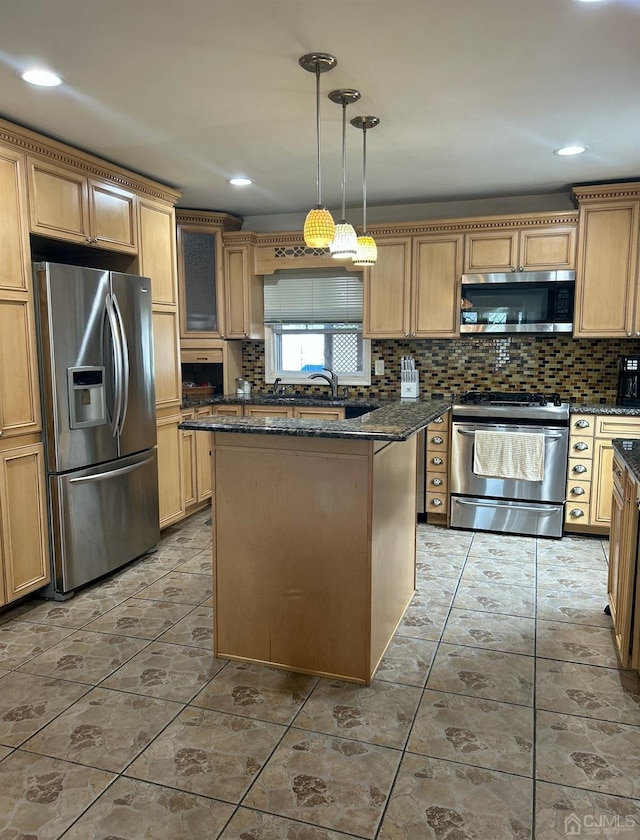 kitchen with stainless steel appliances, a center island, and dark stone counters