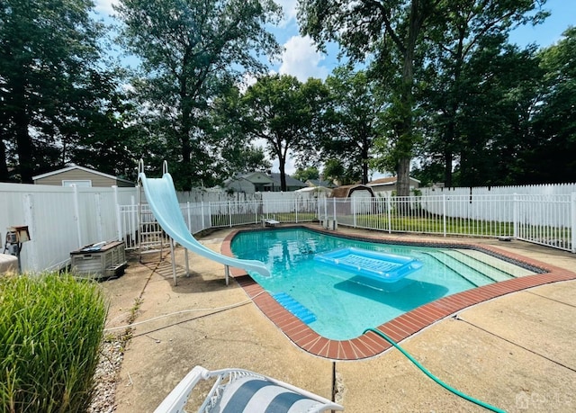 view of pool with a fenced in pool, a patio area, a water slide, and a fenced backyard