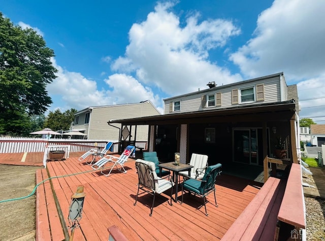 wooden terrace featuring fence