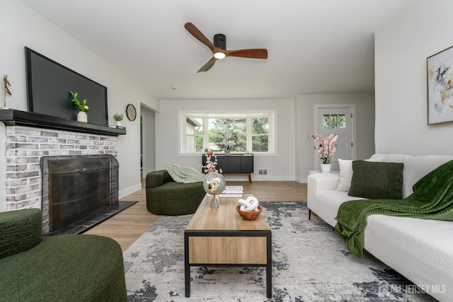 144 Elm St, Dover, NJ 07801 - living area featuring wood finished floors, a ceiling fan, and a fireplace