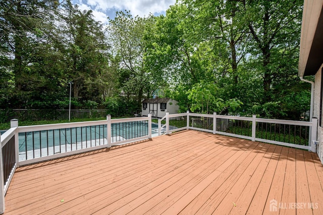 144 Elm St, Dover, NJ 07801 - deck featuring a storage shed, a fenced backyard, and view of wooded area